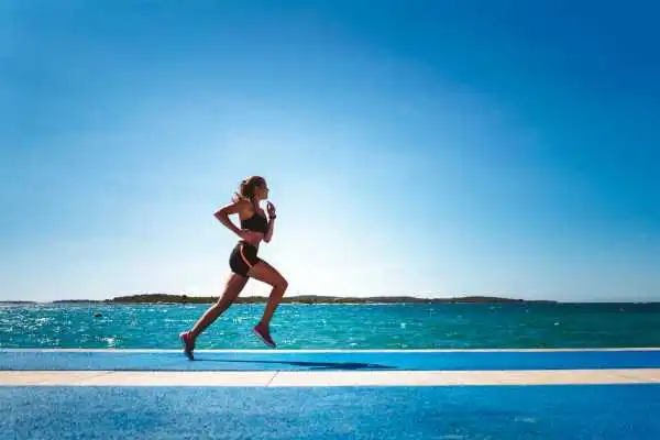 Woman running showing strong leg muscle Hadleigh